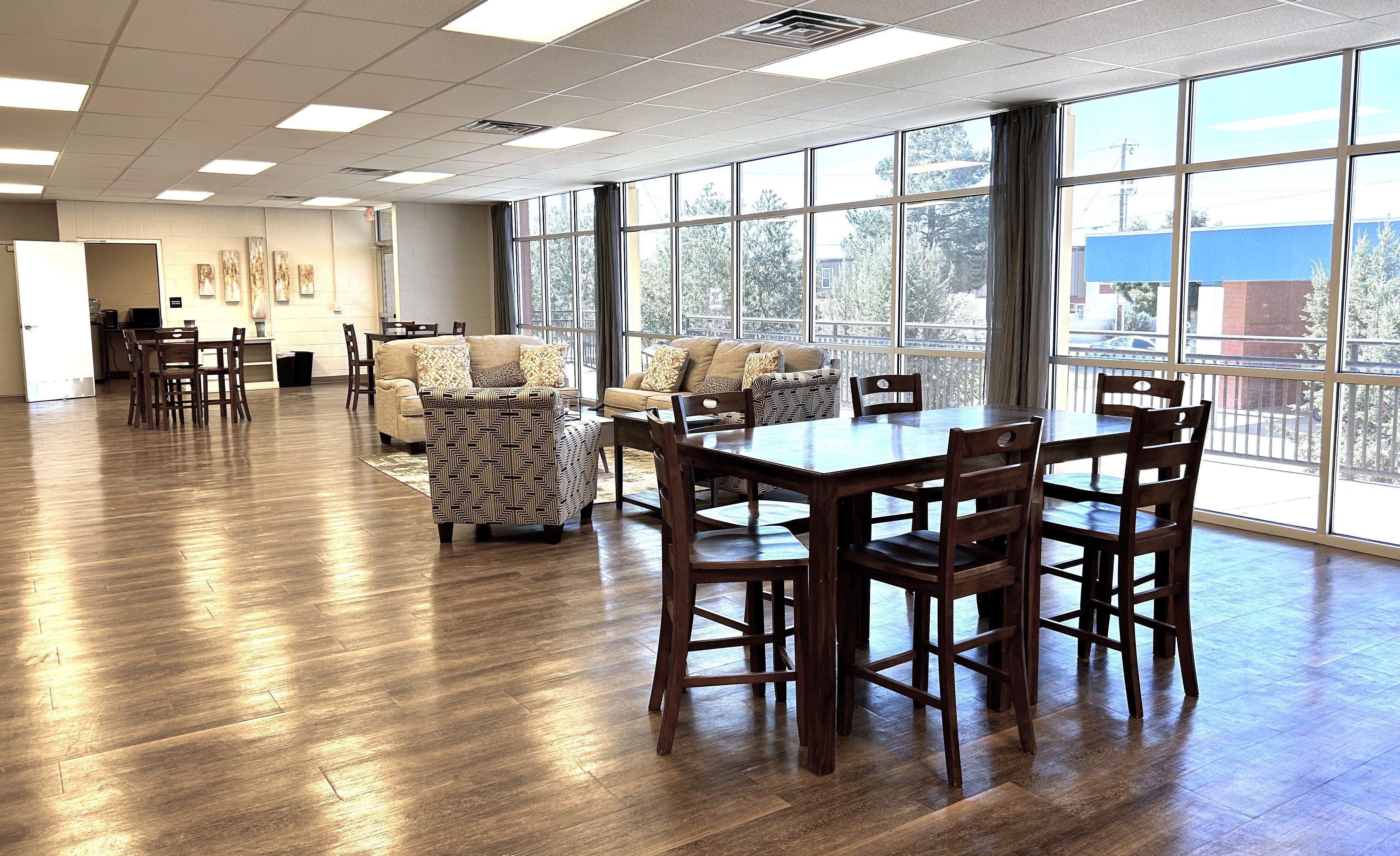 A large room with a long table and chairs.